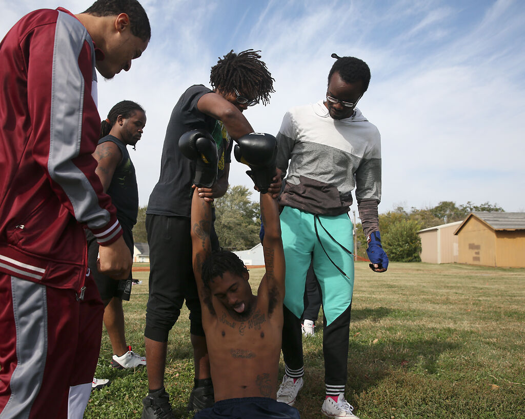Marques Thorpe Sr. has his arms raised above his head to open his airways